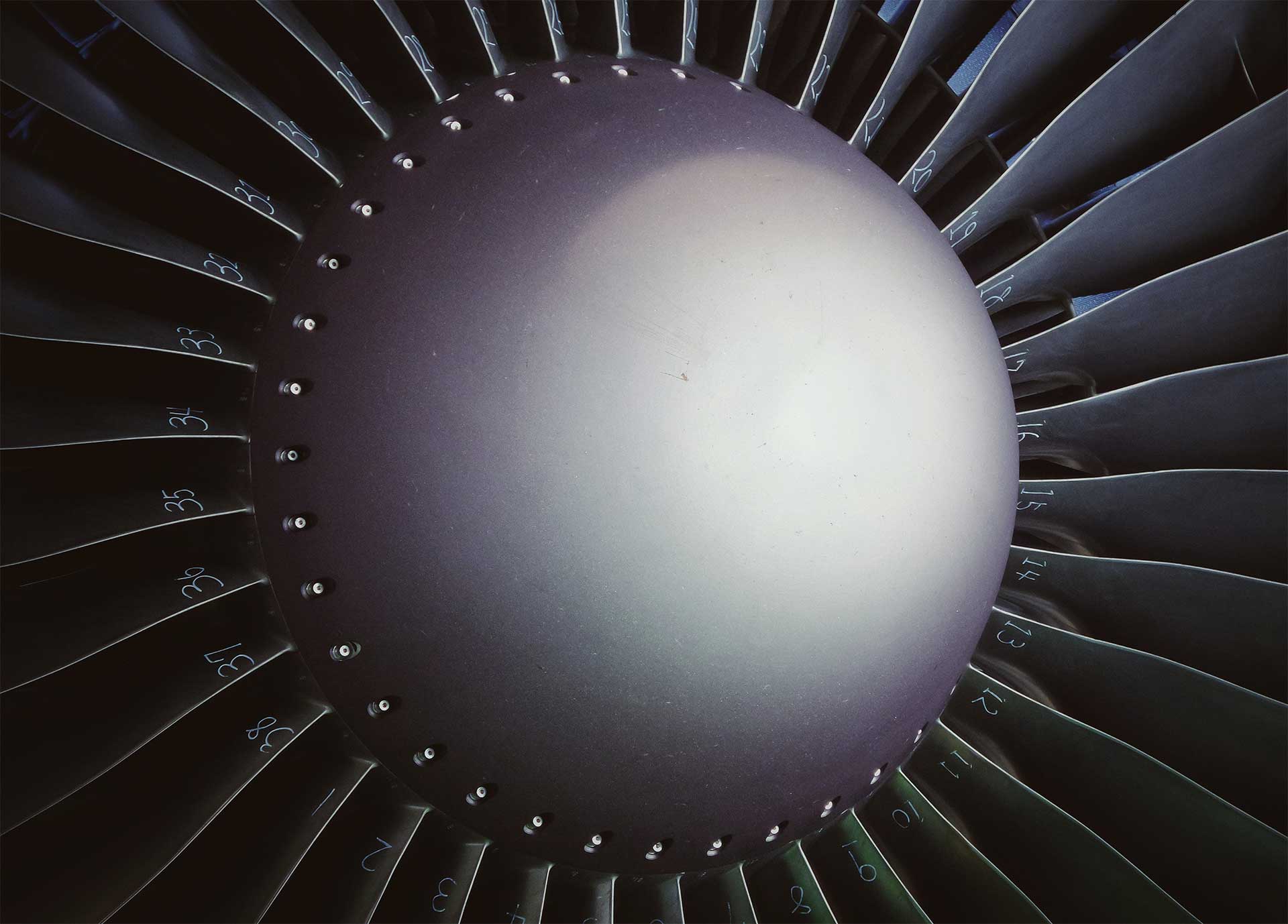 Black and grey blades on a jet turbine. Photo.